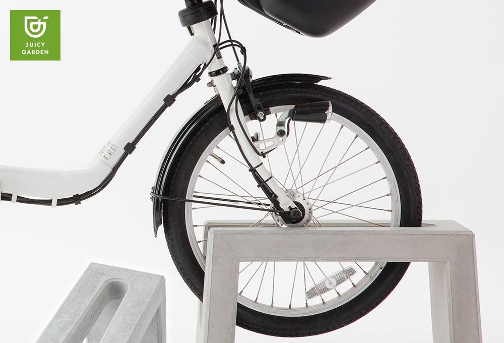 Coco concrete bicycle parking stand - with bicycle front wheel