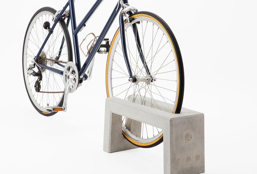 Coco concrete bicycle parking stand - close-up with bicycle wheel